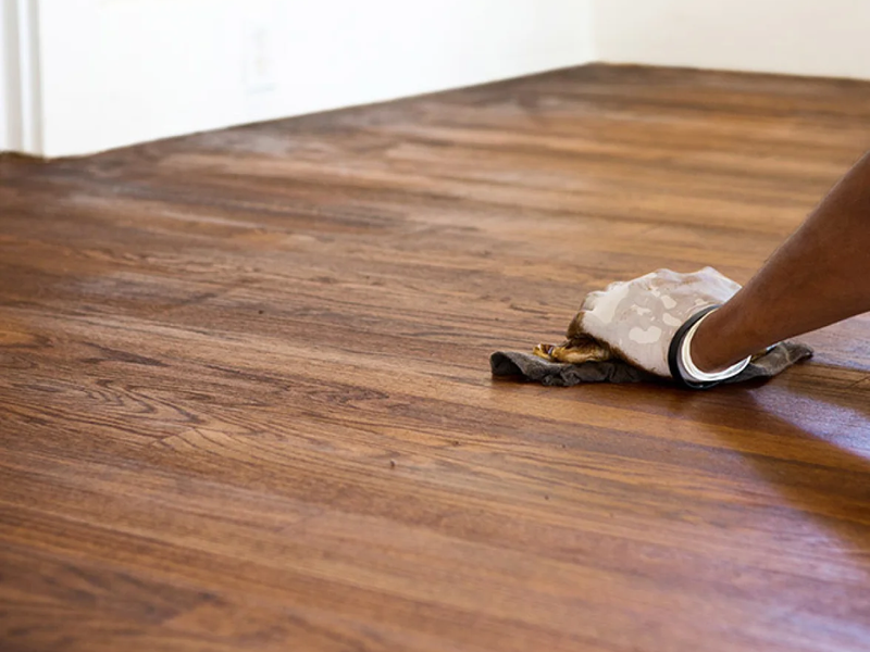 Flooring professional refinishing a beautiful hardwood floor