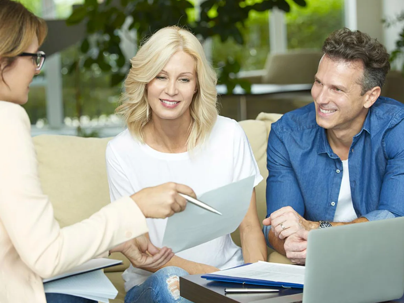 Couple receiving a flooring estimate during a design consultation