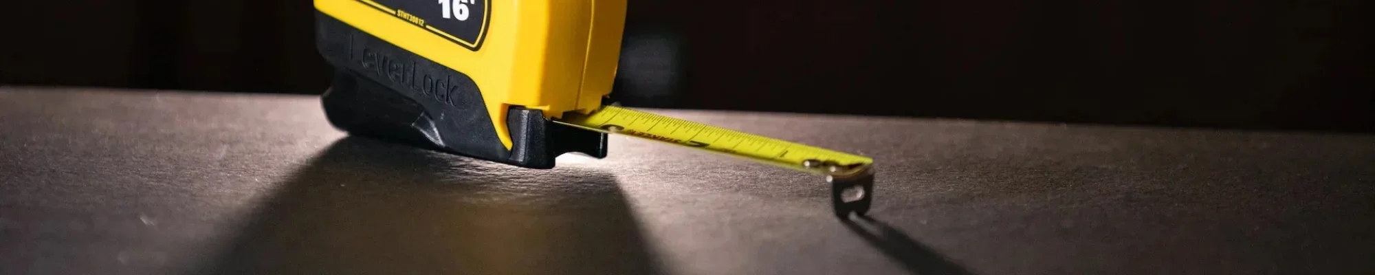 measuring-tape-setting-on-wooden-surface-format.2000x400